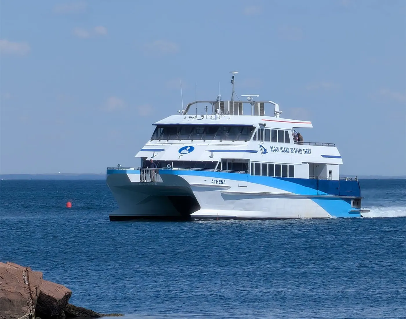 The Block Island Hi-Speed Ferry Athena approaching the harbor breakwater on a clear day.